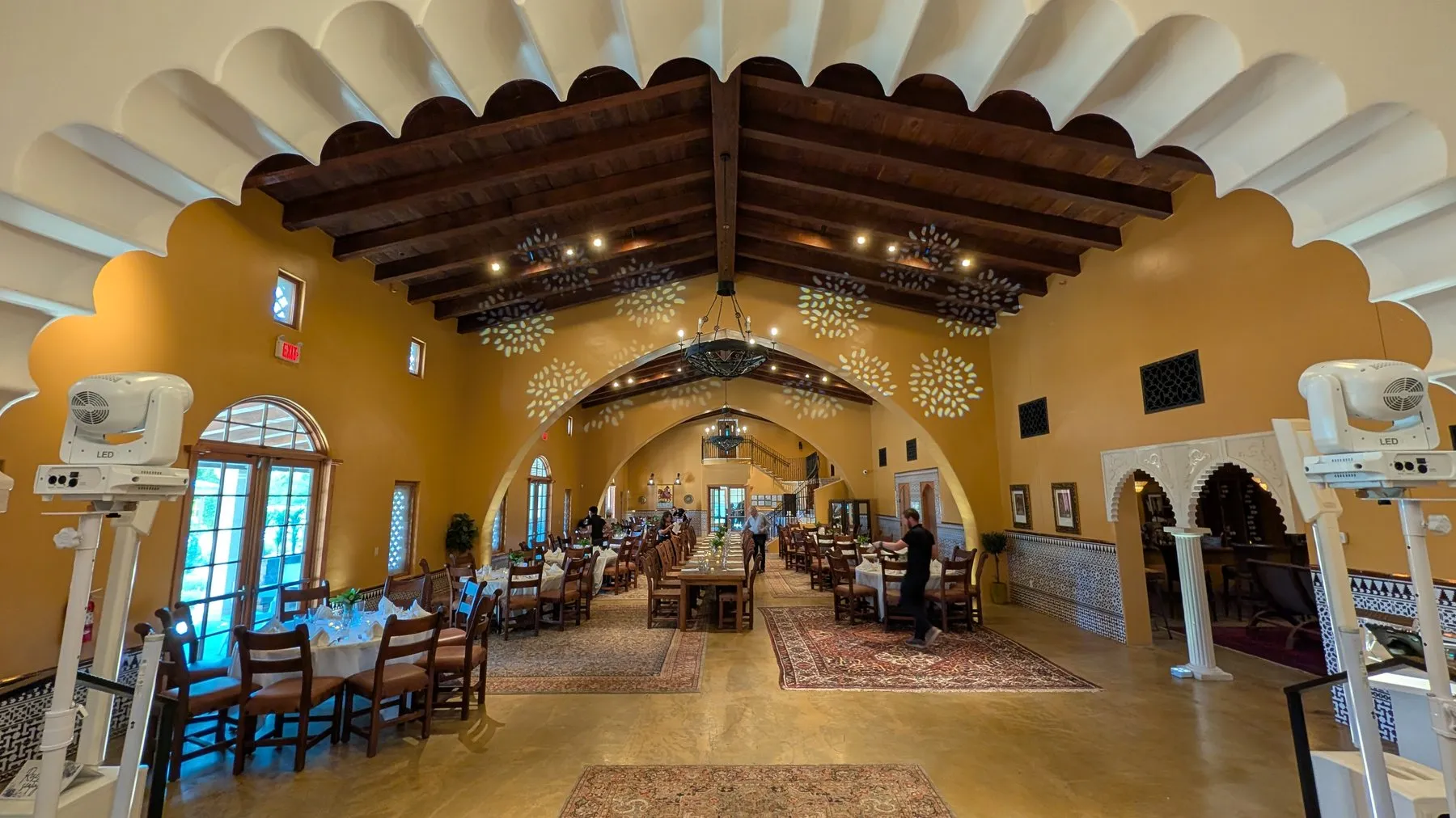 A reception layout inside Animante de Rondeña at Casa Rondeña Winery, with a long banquet table under the vaulted, scalloped-arch ceiling
