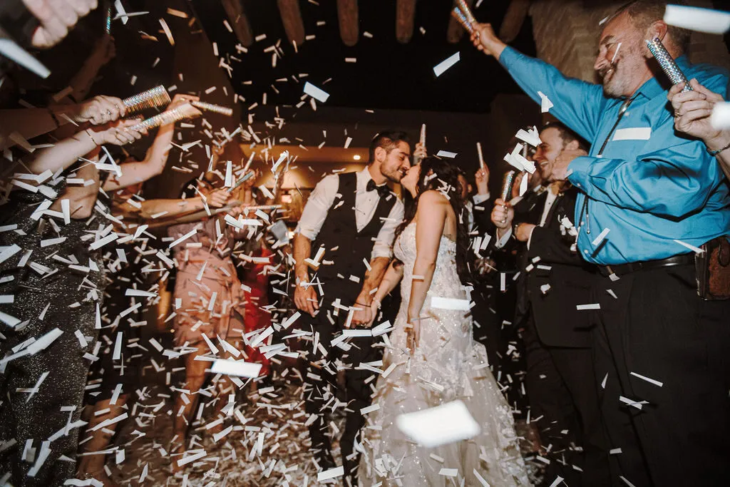 A couple's confetti exit at the end of the night