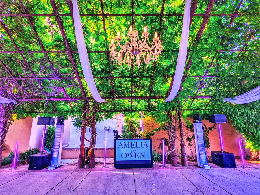 A Cutmaster Music DJ setup under the vine-covered pergola in Hotel Albuquerque's courtyard